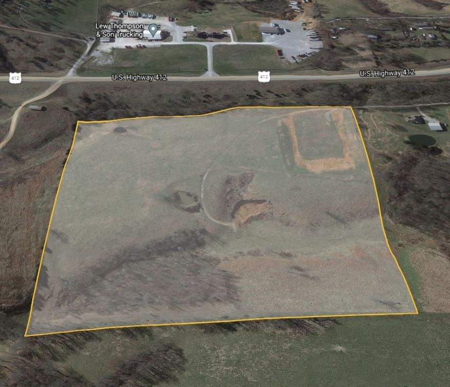 DUZ Zoned development property with approx 1/4 mile frontage along Hwy 412 in Huntsville City Limits.  DUZ zoning is dual-use which allows for commercial & residential, which is a great combination for this property. Sewer, water, electricity & fiber on property. Natural gas along the south side of the Hwy. 2 entrances approved by AHTD.  A large area has already been leveled off. There should be plenty of red dirt on the property to construct an entrance from the Hwy. Great for commercial/residential combination development or a business that needs space.