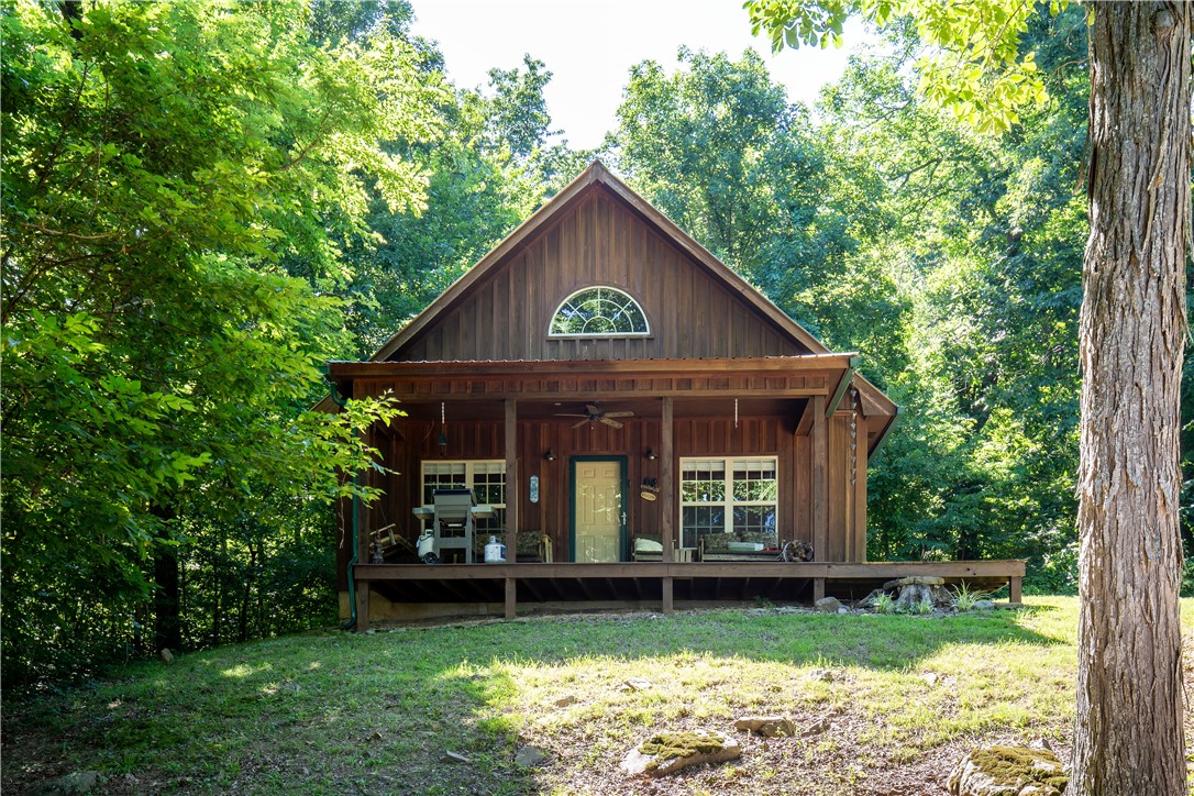Escape to the Ozarks with this 2 bed, 2 bath, 864 sq ft cabin on 6 private acres near Jasper. Currently an active short-term rental, it can also be used as a full-time residence or private retreat. The cabin is located just minutes from multiple access points along the Buffalo National River and is surrounded by smallmouth bass fishing streams, scenic trails, and recreational opportunities. A spacious deck faces east with long valley views. Property is accessed via a short but rough county road and requires a high-clearance vehicle. Nearby attractions include hiking, mountain biking, kayaking, caving, and elk viewing. The area was designated an International Dark Sky Park in 2019. Jasper's downtown is a short drive away with grocery, dining, and other services. Ideal for those seeking privacy and outdoor access! Agent owned.