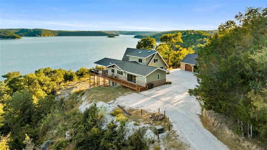 A view that transcends the ordinary, offering a daily reminder of the beauty and serenity of nature. Virtually every aspect of the residence has undergone meticulous renovations with such an extensive list of enhancements you will have to see to believe. Large expansive windows that invite natural light and offer a sense of calm throughout the entire main level. The Living area offers tranquil & comfortable seating with a stocked dry bar equipped with a wine cooler & kegerator. Showcasing top-tier JennAir appliances, instant hot water at the prep sink, concealed downdraft exhaust fan, separate coffee bar, walk-in pantry, & more in this top of the line gourmet kitchen. Luxurious & serene depict the primary oasis.
Situated on the 11-acre property, you'll find a heated & cooled detached 2-car garage, a 3,200 sqft fully insulated shop with oversized garage doors for convenient access. New solar panels power your private boat dock, featuring a 10x20 slip with a lift, two sea doo lifts, and a swim deck.
