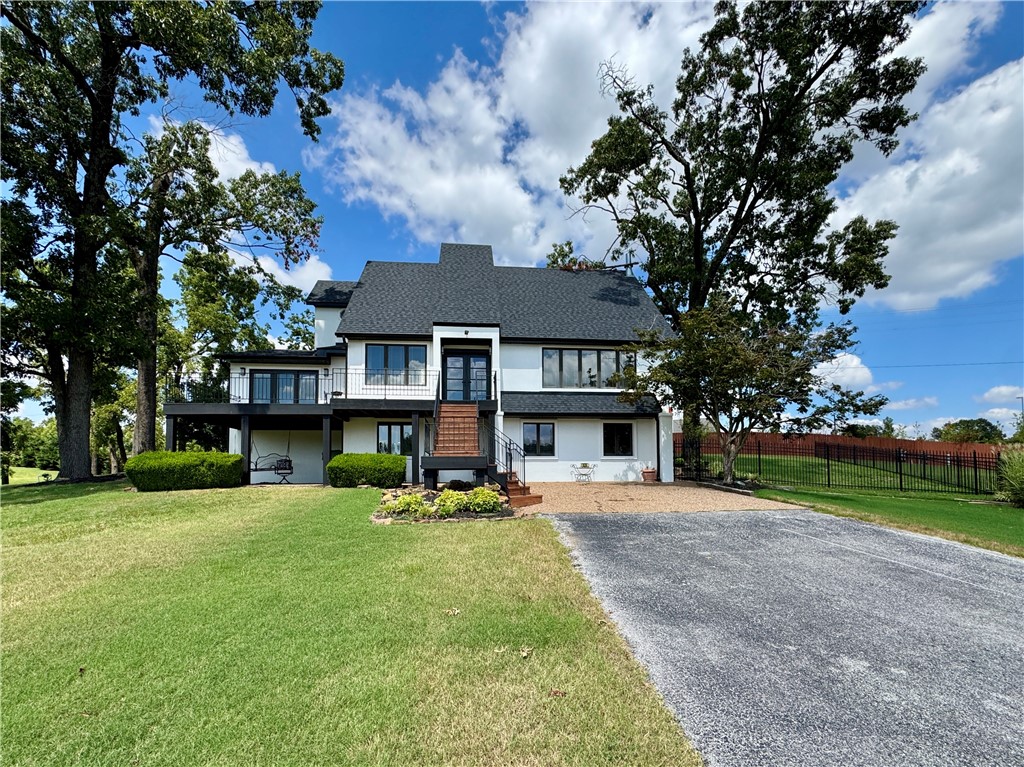 Welcome to this Executive NWA home, a stunning property located in the heart of Rogers, AR. This home boasts 3 spacious BR’s & 2 full BATHS. The home comes fully equipped with all necessary appliances. Interior features gorgeous hardwood floors that add a touch of elegance to the space. The full basement is not just a basement; it's an entertainment hub with a home bar & endless storage. For those who work from home, the large office space is a dream come true. A beautiful wrapping deck that overlooks your front lawn acreage with plenty of deer. Take a night swim in your private pool oasis, complete with a cute pool house. The property has iron wrought fencing for part of the back yard & the pool. The huge separate 3-car garage with a shop area is a bonus for car enthusiasts & extra storage. This home is part of a very private compound with two other homes, offering a sense of community while maintaining your privacy. Located next to Lisa Academy. The Executive NWA home is more than just a house; it's a lifestyle.