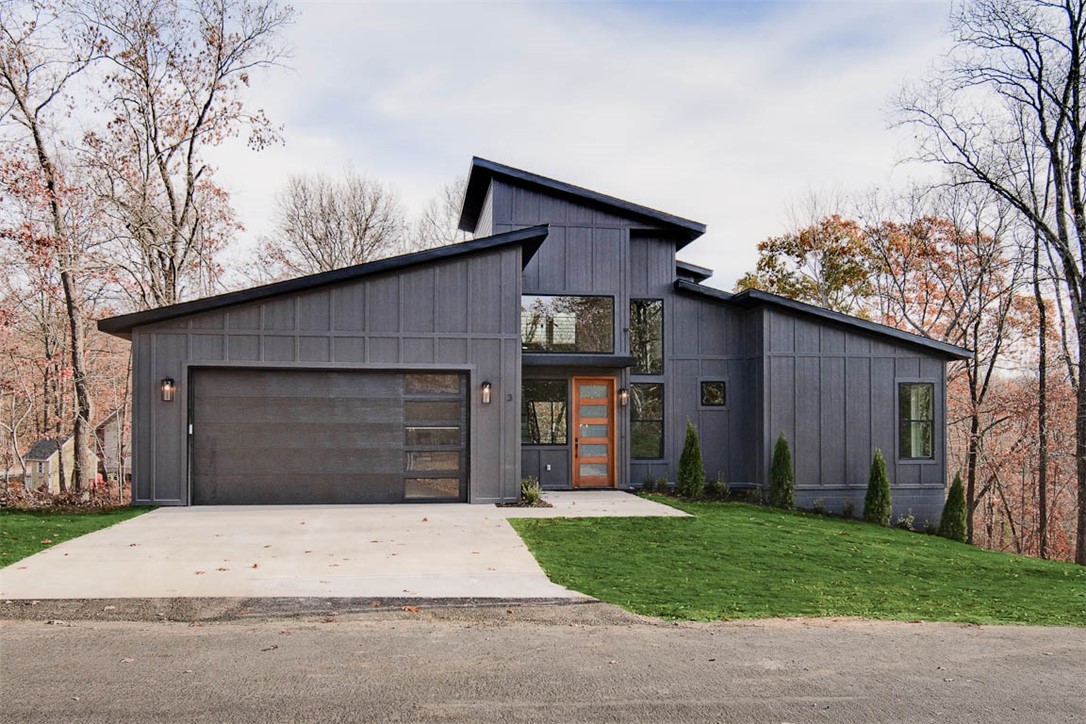 Modern luxury w/ quick access to the Back 40 Trailhead, Metfield Golf Course, & downtown Bentonville! This home boasts a large bonus room w/ full bath that could also be used as a 4th bedroom. Step inside to discover custom high-end finishes throughout, including a spacious kitchen featuring floor-to-ceiling cabinets & a grand island illuminated by LED lighting. Equipped w/ Frigidaire Professional appliances, including a gas range & fridge. The primary bath offers the option of a frameless glass shower. The hardie-board exterior creates exceptional curb appeal, while the interior showcases a striking fireplace, custom staircase, & beautiful hardwood flooring. The garage features epoxy floors. Pre-wired for a 220-car charger & hot tub on deck. Enjoy the outdoors from your oversized covered composite deck, complete w/ a stunning wood ceiling & custom railing that overlooks your wooded lot. $3,500 lender credit available! Sewer lot. Approx completion date is 9/15/25
