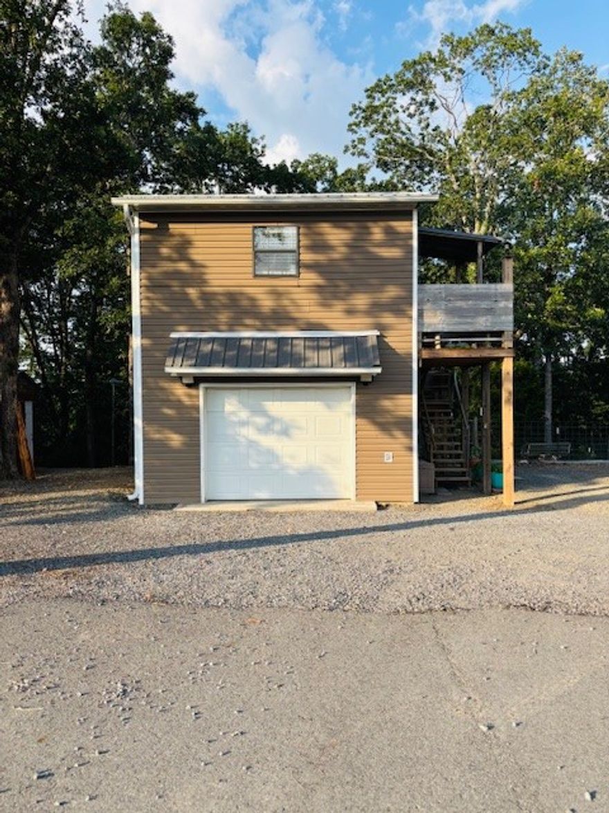 Rare 9-acre multi-use property with Hwy 65 frontage! Includes 2 homes & 2 RV hookups w/dedicated electric. Main home: 1 bed/1 bath, 2-story w/escape hatch, spray foam insulation, 6” walls, fenced yard, & garage w/heat/air, electric, & small kitchen. Cabin: 1 bed/1 bath w/view of year-round creek & seasonal waterfall—great for Airbnb, mother-in-law, or teen space. Features 40’x9.5’ storage container, French drains, grape vines, fruit trees, chicken coop, 50-yr metal roofs (2024), well w/filtration system, laundry in well house, propane backup, city water access, circle drive. All appliances inside the homes stay. Surveyed; mineral rights may convey.