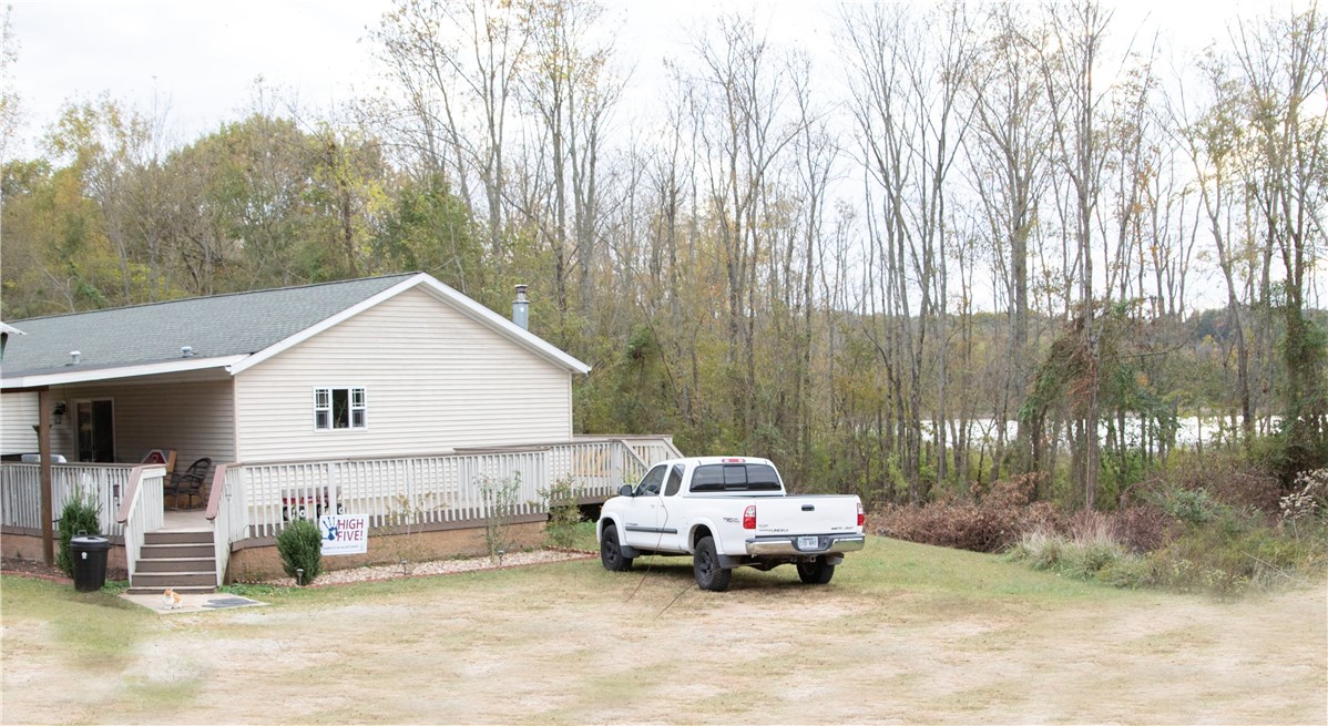 Enjoy the beautiful Beaver Lake view/frontage in this beautiful move-in ready property with 3.06 acres.
The double wide manufactured home open floor plan includes two living rooms, open kitchen floor plan with SS appliances, 3BD/2BA and 2 full bathrooms. Large master with attached master bath has whirlpool garden tub and walk-in closet, with a separate shower area. Property sits on a foundation.
Also has a detached 20x20 garage/workshop. New 2019 HVAC Air handler and 2018 roof. Enjoy your evenings in your front porch as you enjoy the serene and beautiful seasonal Lake View, deer and wildlife.
Property is in prime location, near entrance to War Eagle Marina and Park, yet close to town.
Chicken coops do not convey. Outdoor playhouse with slide is negotiable.