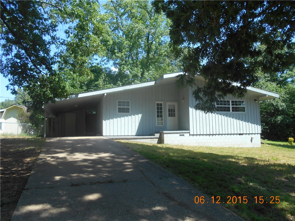 Cute 2 bedroom, 1 bath home w/ covered carport, deck area, & fenced. Refrigerator, stackable washer & dryer (convenience items only) & built-in microwave. Propane heat. Newer carpets.
