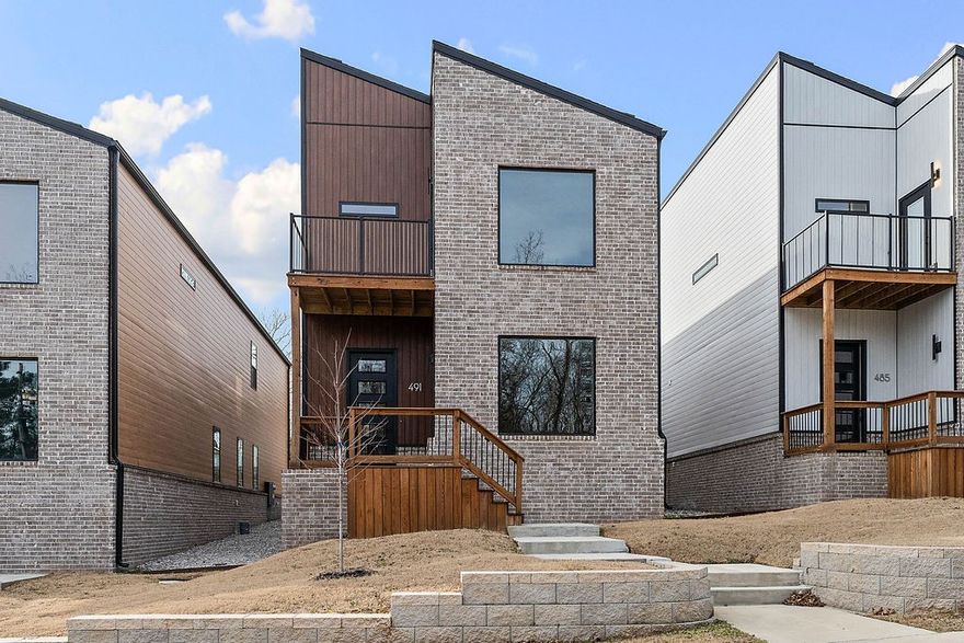 Experience the height of modern luxury in this beautifully designed urban retreat. Blending contemporary style with thoughtful functionality, this home features an open-concept filled with natural light from expansive windows, creating a bright and welcoming ambiance. The kitchen is a true centerpiece, complete with quartz countertops, custom cabinetry, and stainless steel appliances—perfect for both entertaining and everyday living. Flowing effortlessly into the spacious living areas, it sets the stage for cozy family dinners. Upstairs, the primary suite offers a peaceful escape with vaulted ceilings, a private balcony, and a sleek en-suite bathroom with a stunning tiled shower. Additional bedrooms also feature vaulted ceilings and share a second bathroom finished with modern touches. Step outside to a large rear balcony, ideal for outdoor entertaining or unwinding under the stars. Situated just 2 miles from the lively Dickson Street and Fayetteville Square, you’ll enjoy quick access to top dining and shopping.