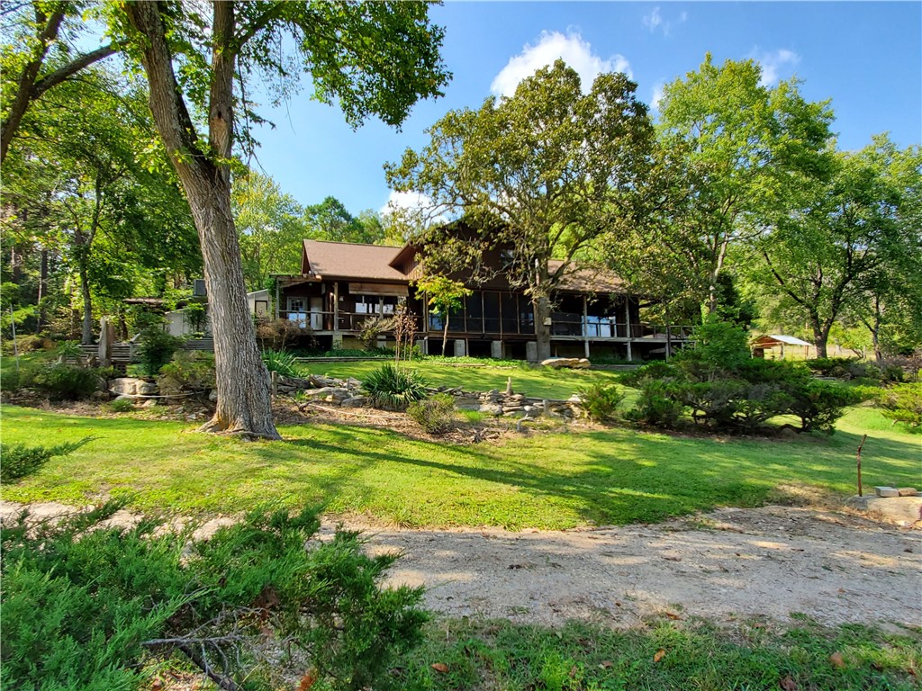 Looking for a homestead property, this is it! Private gated drive to home on 48.47 acres of pasture and some woods. Fenced and cross fenced for livestock. Spring fed pond with pier and a year around creek runs through the property. Home features screen porch off the living room to enjoy the sound of the babbling creek and wildlife. Just off the kitchen is a large green house to extend your growing season with propane heat. Sit in the living room and relax by the fire on those cold winter days. Basement has a workshop area along with a safe room and plenty of room for your canned goods. On the main floor is all your living space with 2 bedrooms sharing a full bath and the master suite with walk in closets and full bath. On the upper level is a convenience apartment for guests or rent out for additional income.