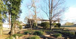 Sitting pretty on the side of the hill is where you'll find this 3BR 3BA home with two living areas and the coolest enclosed patio with fireplace! You can enjoy the fire in cooler months and view of the pool in the summer. See it today! Property Sold AS-IS
