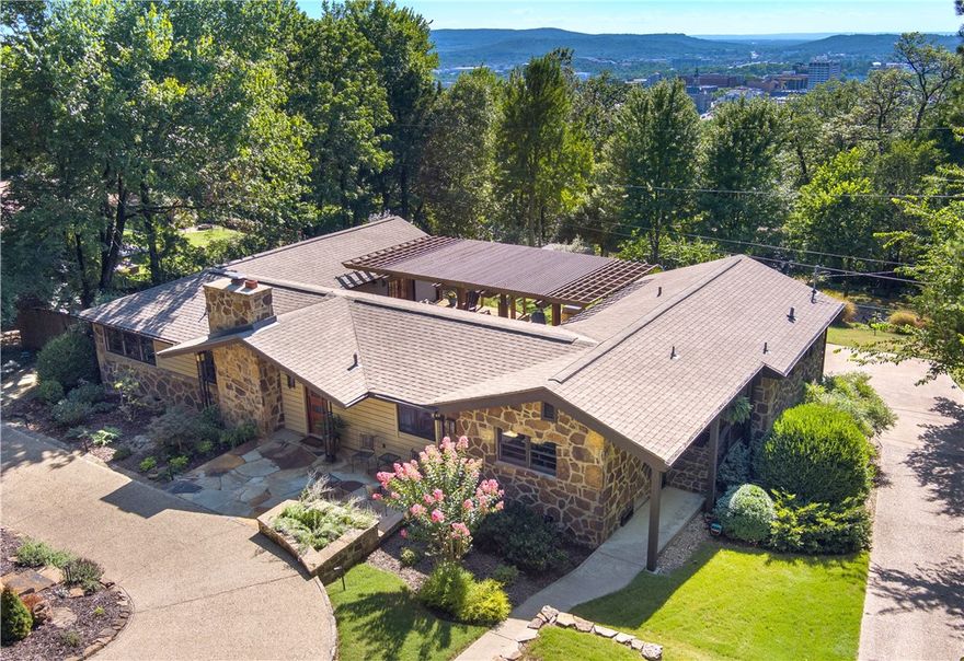 Be the first to see this beautifully renovated mid-century modern home located in East Fayetteville on the desirable Mount Sequoyah! This 3 bed/3 bath home is within walking distance to ONF, Dickson and the Square, making it perfect for those wanting to be close to downtown activities! Updates to the outside include a new facade, stone patio, new gable roof, and professional landscaping. This home features a solid Sapelle mahogany front door built locally, hardwoods throughout the home, a fabulous kitchen with an oversized island made for entertaining, and arched entryways allowing for an open-floor concept. Downstairs also includes a second living room and a bonus room that would be great for a future home gym. Attractive wood-encased windows with matching trim flow seamlessly throughout the two-stories, allowing abundant natural light and spectacular views. You can even enjoy a cup of coffee in the mornings on the extra-large private deck where you can spot Old Main or the Stadium after the leaves fall!