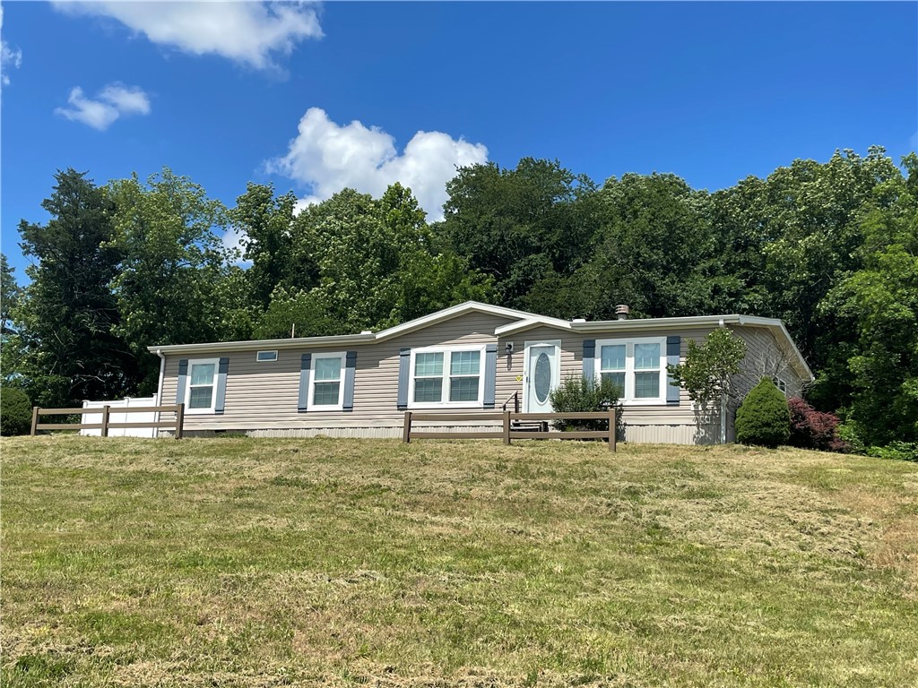 This nice 3br/2ba double-wide manufactured home sits on a roomy 10.24 acres in a country setting with beautiful Ozark views. This property boasts both open ground AND over 7 acres of woods to call your own. With 2,010 sqft of living space, the home offers plenty of room for your family to enjoy. Inside, you find an open feel with spacious kitchen suited for gathering, amazing primary on-suite bathroom, bonus office/sitting area, wood-burning fireplace, and an abundance of storage throughout. Outdoors, you find an additional 240 sqft building for workshop or storage, lots of open ground surrounding the home for future garden or other projects, and wooded acreage to explore the outdoors. Short drive to pavement, 10 minutes to Huntsville and all the necessities. Lots of possibilities with this peaceful property! Schedule your showing today!