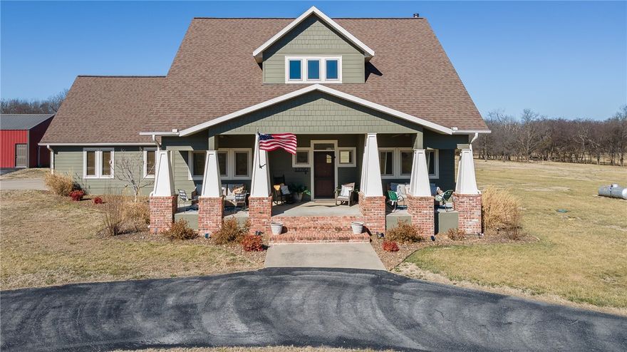 Stunning custom-built Craftsman on 5 acres offering character, comfort & thoughtful updates throughout. The inviting covered porch opens to a light-filled, open floor plan with hardwood floors, a warm wood-burning fireplace & a dedicated office ideal for working from home. The kitchen features granite countertops, stainless steel appliances, butcher block island, farmhouse sink, gas cooktop with pot filler, double ovens & built-in microwave, all flowing seamlessly into the dining area. The primary suite offers vaulted ceilings & a spa-inspired bath with brick flooring, soaking tub, oversized walk-in shower & double vanity. Since 2021, sellers have completed extensive upgrades including full interior repainting (including cabinetry), high-efficiency can lighting, select window replacements, waterproofing improvements with new sump pump & backyard leveling for improved usability. A 1,200+ sq ft shop provides incredible space for hobbies, storage, equipment or workshop needs, all set against peaceful country views.