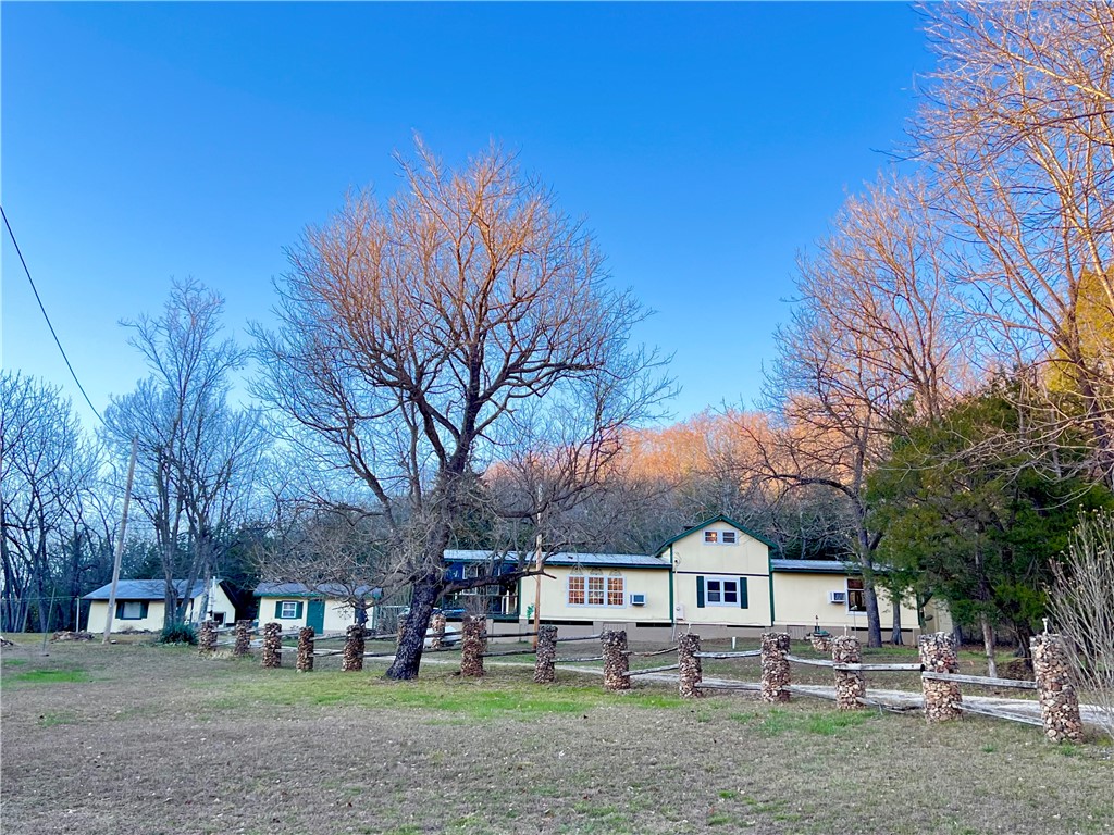 Nestled down a quaint county road on 20 unrestricted acres sits a unique & well constructed 2bd 2ba home with lots of additional lovely outdoor living space to take advantage of. The main floor houses everything you need to be comfortable including a very spacious living/great room, Kitchen, laundry, a home office and a super spacious bedroom with a lovely ensuite bathroom. The upper half story currently has a guest bedroom and a craft/hobby room that could be utilized as a third bedroom. The land that this home sits on is spectacular. It is a full 20 acres of heavily wooded private terrain. The home sits near the front of the acreage. New sliding doors open up to a whimsical back courtyard and covered patio area that is perfect for a hot tub. There is also a covered front deck, an adorable heated she shed and a heated and cooled man cave complete with bar, mini fridge, & dart board for entertaining friends on game day. Raised bed gardens, a chicken coop and an equipment building will help seal the deal on this one