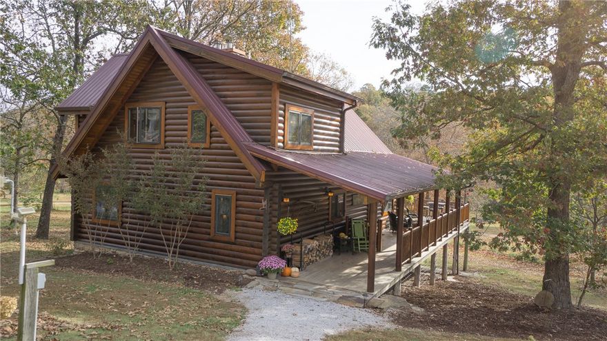 Stunning custom built log home, wrap around deck, overlooks spring fed, stocked, 2 acre lake & private dock. The 80 acres is surrounded on 3 sides by Ozark National Forest, ultimate seclusion, yet 25 min. to Fayetteville & 20 min. to Siloam Springs. Open concept, SS appliances, 2 wood burning stoves, oak flooring & pine cabinetry. Walk out basement with second family room, game area, and wet bar opens to beautiful covered patio. 1500sqft, insulated, electricity, metal building, concrete floor.