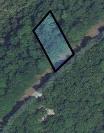 Scenic Lot in the Lake Area of Lost Bridge Village! Situated near the Private Air Strip at Lost Bridge Village, this property boasts additional amenities such as a recreation center and a swimming pool.