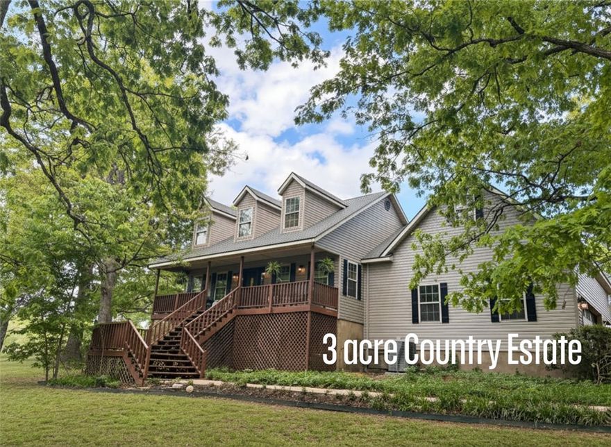 Beautiful views, outdoor living spaces, inviting landscaping and more. Country living with city convenience.  Open floor plan is perfect for family time or entertaining.  Counter space for cooking up a storm & built in desk.  Vaulted bonus room. Cozy up to the wood burning fireplace or hang out on the spacious decks outside.  If floating in the pool is more your style, then we've got that covered as well.  Handy to all areas of NWA.  All new back deck and around the pool.  Roof, some siding & HVAC replaced in 2026. Attached 2 car garage & 2 car detached garage for all your toys.  Too many amenities to list so come see it in person.  Final lot split for 3ac & house is approved and recorded. The 2 acre lot to the west has been finalized as separate parcel. The City of Tontitown has stated they will be making Theresa Ln into a two lane road.