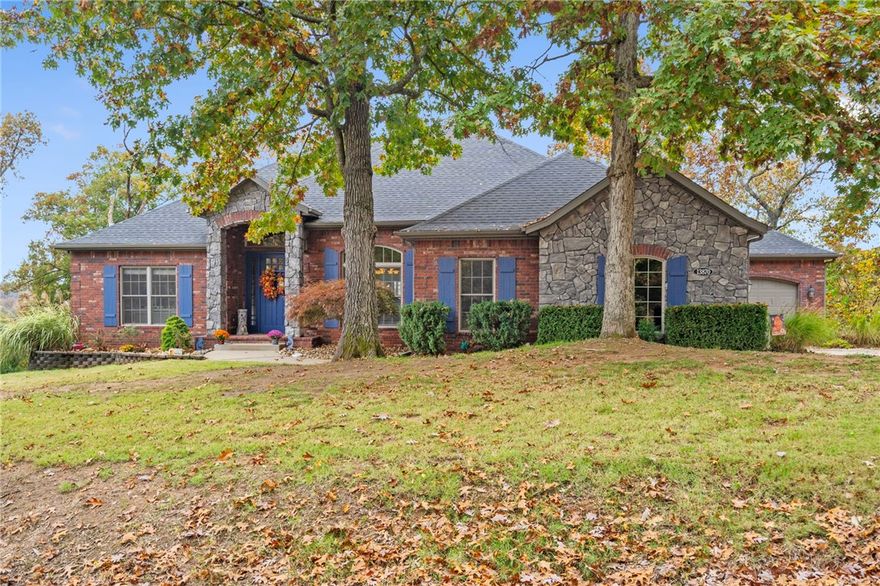 Discover the essence of Ozark beauty just 5 minutes from Downtown Rogers by Beaver Lake. Nestled on nearly an acre lot, this residence is located within a gated community and boasts seasonal lake views. The main level of the home features an open floor plan seamlessly integrating both an eat-in kitchen and a formal dining area. An office, half bath, oversized utility room, and the primary suite complete this level. On the lower level, a walk-out basement includes an expansive bonus living area, three bedrooms, a half bath, a Jack-n-Jill bath, a generously sized storage area, and a versatile room. The outside deck has two levels, and has been updated to enhance outdoor living. From the top level, experience seasonal lake views and amazing nature vistas year round. A 3-car garage caters to practical needs. Perfect for multigenerational families, growing families, or individuals who love to entertain, this spacious and beautiful home is the ideal blend of privacy and tranquility.