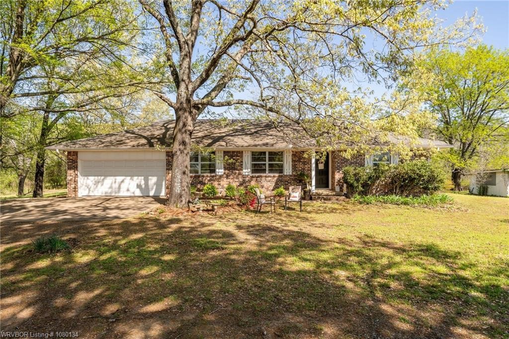 Nestled among mature oaks and pines, youāll find this well maintained brick 4-bedroom, 2.5-bath home sitting on approx 4.93 acres. This home has a spacious family room with vaulted ceilings and a wood-burning fireplace plus an oversized dining room to gather all your family and friends. Youāll love the kitchen updates with granite countertops and modern backsplash. The primary bedroom has a spacious closet suite and a bathroom with his and her vanities. One of the biggest highlights? The oversized 4th bedroom with its own exterior entranceāgreat for guests, a home office, a man cave, or even a game room. Endless possibilities! Step outside to enjoy your in-ground pool and a fenced backyard with black chain-link fencingāideal for kids or pets. Gutters with leaf guards and a brick / siding exterior means less maintenance for you. Close to the interstate (.6 miles) but still with a quiet, secluded back yard, this one checks all the boxes! Also a 16 x 24 storage building on a concrete slab with electric.