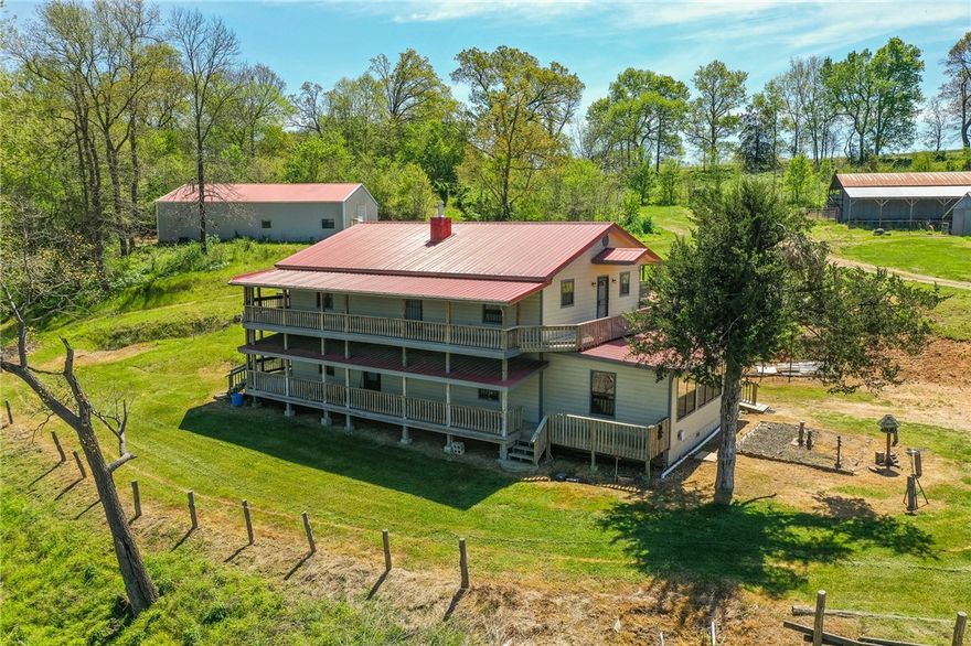 Farm life meets convenience! Two minutes off 412, located in Hindsville. This handicap accessible, two story home is the perfect balance between comfortable living and farming. Four bedrooms, two primaries located on the main floor, with two additional bedrooms upstairs. This home features breathtaking views, a handicap accessible elevator, and wrap-around porches. On the property you will find a 40 x 60 drive thru shop with a full size kitchen, two stoves and several storage closets; a storm shelter right off and behind the house; a hay barn; a cattle corral; and a bench-seated pavilion. Don't forget the huge garden with irrigation. Glade Creek winds throughout the property, offering occasional glimpses of deer, herons, and other wildlife. Beautiful build site on property as well! There is so much here that you have to see it for yourself! Listed as farm MLS#1275759