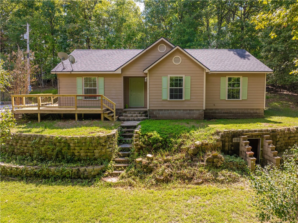 Escape to your own private retreat on 3.55 wooded acres just minutes from Beaver Lake. This charming 3-bedroom, 2-bath home offers 1,292 sq ft of comfortable living space surrounded by mature trees and natural beauty. The gently sloped lot provides both character and opportunity, with room to expand, garden, or simply enjoy the peaceful setting. Inside, the home shines with thoughtful updates, including a new roof, fresh paint, and all new flooring, making it truly move-in ready. Whether you’re looking for a full-time residence or a weekend getaway near the lake, this property combines modern updates with a serene, wooded backdrop.