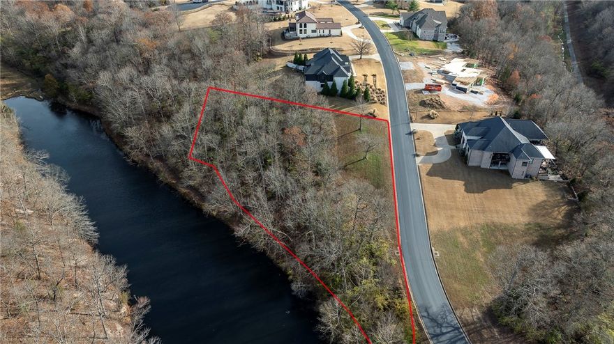 Prime wooded luxury home building site in an exclusive neighborhood. 
Breathtaking lake views from your custom home's back porch. 
Convenient access to shopping, schools, U of A, and healthcare facilities in a serene subdivision. 
Choose your own builder with protective covenants and architectural control committee to safeguard your investment.