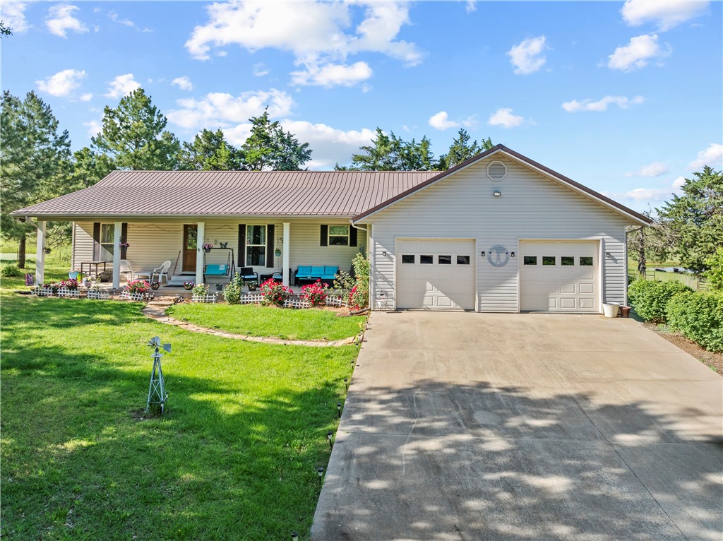 Well-kept 3-bedroom, 2-bath home in Harrison, AR with great features inside and out. This home offers a durable metal roof, leaf gutter guards, fenced yard, and covered front and back porches ideal for relaxing or entertaining. Inside, enjoy newer carpet, a spacious primary suite with a claw foot tub, double vanity, and a walk-in closet. The washer and dryer convey, making move-in easy. A 2-car garage adds convenience and storage. The home is located only 30 minutes to the Buffalo National River to the southeast and 30 minutes to Branson, MO to the north. Its the right mix of country living but just a few mintues to everything you would want to do. Located with quick access to local amenities, this property combines comfort and function—ready for its next owner. Schedule your private showing today!