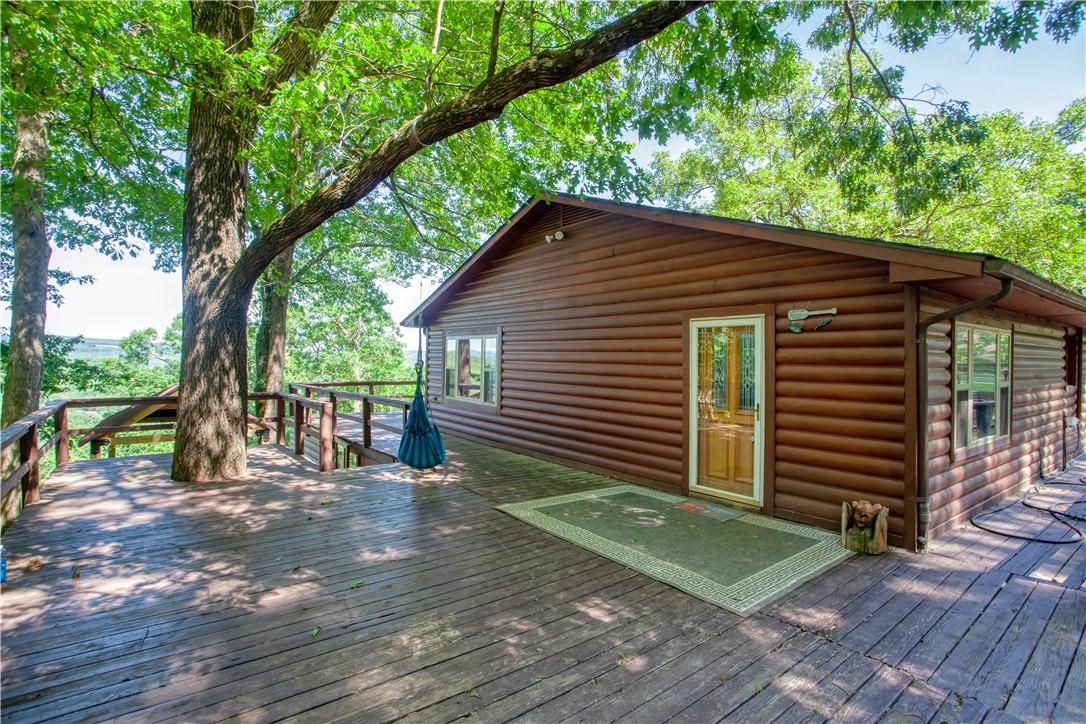Want that secluded feeling but only 5 minutes from the interstate? This is the place! 4 bedroom 3 bath home sitting on 26+ acres with a beautiful view from the almost 2,000sqft deck! Abundant wildlife makes it perfect for the hunters or the ones that just want to enjoy the nature and animals. Two levels, upstairs is the main living with the master bedroom/bathroom and guest bathroom. Downstairs is a 1,000sqft with 3 bedrooms and 1 bathroom. Above ground pool, hot tub, playhouse and open yard area is great for entertaining or just relaxing. City water but property does have a well house with newer pump, greenhouse and new propane tank that conveys. HVAC and water heater replaced in 2020. This could also be a great Airbnb! With several other successful Airbnb properties in this area and Lake Fort Smith being just minutes away, it could be a wonderful vacay spot and investment!!