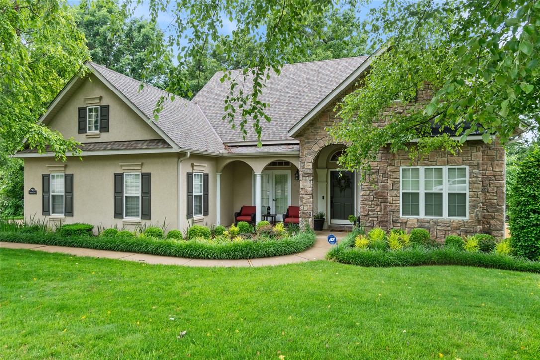 Immaculately maintained, beautiful home located in highly desirable Northwest Bentonville. Custom molding throughout and transom windows. French doors and rubbed bronze fixtures thought the home. Gas fireplace with stone facade, ceiling fans all rooms with blinds on all windows. The kitchen, hearth room and breakfast room all have a beautiful brick flooring. The home currently has two Master bedrooms or ensuites; one wall and door could be replaced to make this a 4-bedroom home if desired. Large laundry room with extra storage and sink. Extensive storage inside and outside. New "Cottage Style" roof and gutters 2025. Access to Bentonville trail system at subdivision entrance. In a subdivision of larger more expensive homes. You won't want to miss the opportunity to view this outstanding listing, make your appointment today.