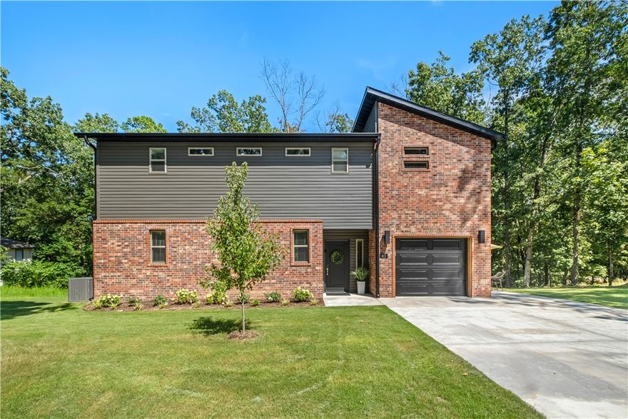 Just minutes from Lake Park and the Back 40 Trails - Don't miss this prime Bentonville home --perfect for outdoor enthusiasts! 2 bed 2.5 bath with 1 car garage.  This "Like New" home features open kitchen layout with beds and laundry upstairs.  Extra driveway parking and backs up to a common area leading to Lake Ann. Great for an AirBnB - rental history available.
