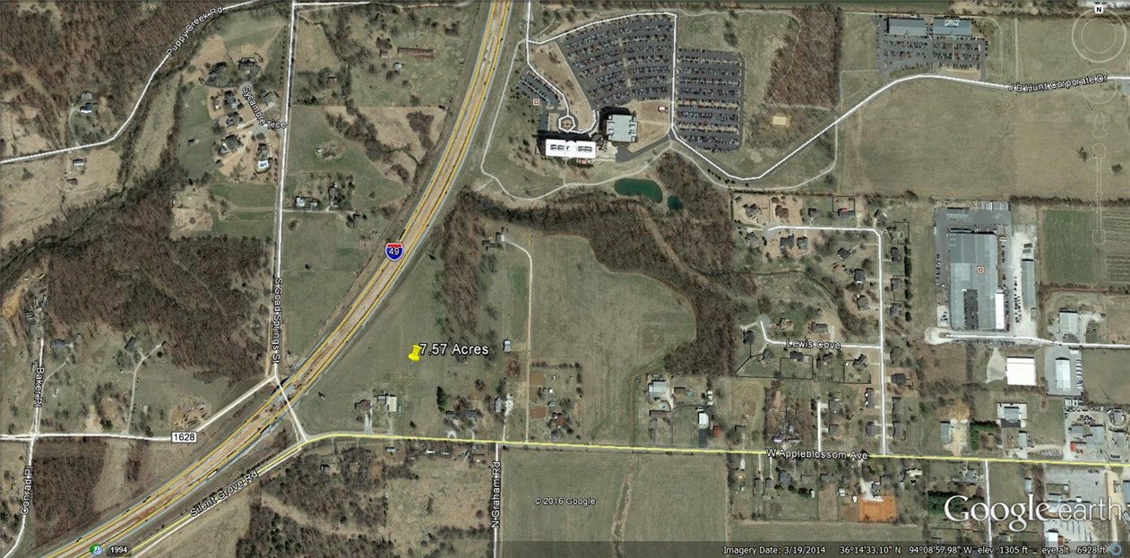 Beautiful tract of land visible from I-49. 16 inch water line on south side of property. No sewer on property. 15 inch sewer line 200-300 feet north of property. At the intersection of I-49 and new 412 Bypass. Excellent location for office park or mixed use development.
