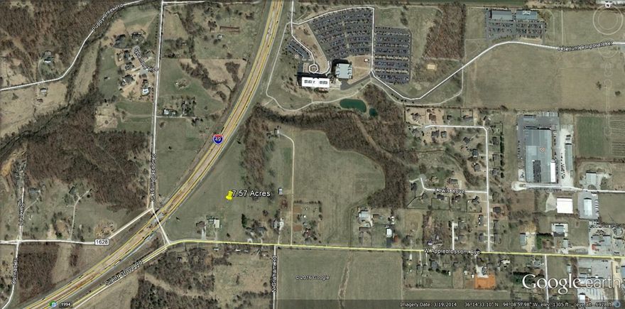 Beautiful tract of land visible from I-49.  16 inch water line on south side of property.  No sewer on property.  15 inch sewer line 200-300 feet north of property.  At the intersection of I-49 and new 412 Bypass.  Excellent location for office park or mixed use development.
