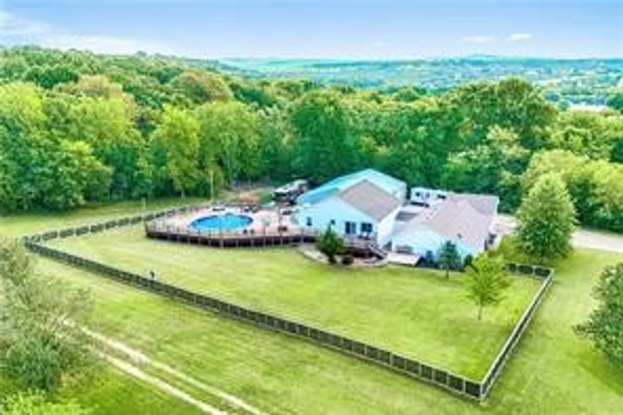 LIMITLESS OPTIONS FOR FAMILY, INVESTORS, AT HOME BIZ OR EVENTS AND 6 MINS TO THE UNIVERISTY OF ARKANSAS! This pristine land & unique tri-level home offers a heated pool & hot tub, sustainable green living w/ a geothermal HVAC system, all new Low-E windows, exterior security sys., brand-new roof and all newly updated appliances + multiple living spaces, 2 kitchens & laundry on each floor. Upper level has living area w/ dual-oven kitchen, 3 bed & 2 bath. Mid level has 3 bed, 3 bath, kitchenette + direct access to deck & pool. Lower level is ideal for entertaining or multi-gen living w/ tall ceilings, kitchen, theater, laundry & bath. Outdoor oasis w/ pool, wrap-around deck & hot tub. Perfect for relaxation & gatherings, the impressive theater room is perfect for game days & movie nights. This isn’t just a home, it’s an opportunity. A 2,400 sq. ft., 3-Bay, climate-controlled shop is a dream for a biz owner, car-enthusiast or artist w/ 10 ton car lift, compressed air plumbing, welding setup, 1/2 bath + pickleball court