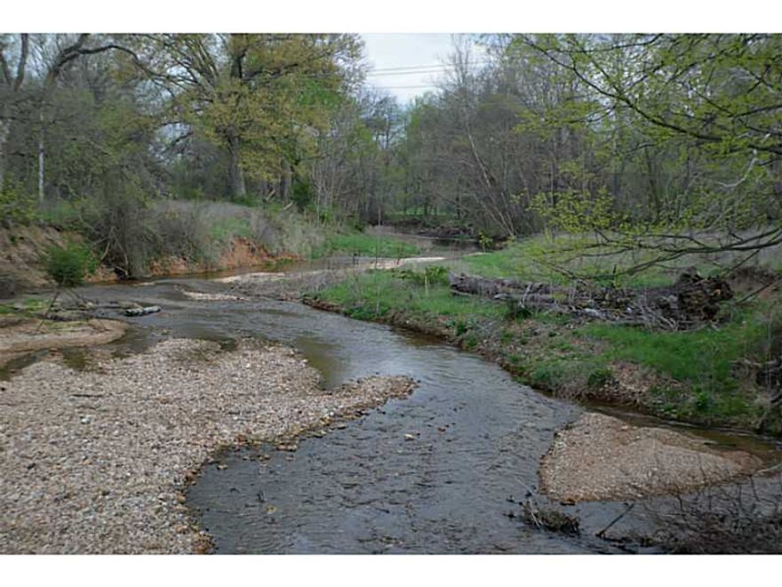 Breathtaking views, Spavinaw Creek frontage, and a spring along the back, 2 ponds, all fenced describes this wonderful property  Mostly open pasture, some tree cover.  The property has a little farm house, a hay barn, 2 car detached garage,and a cellar.,Build your dream home and watch your cattle roam the pastures.
