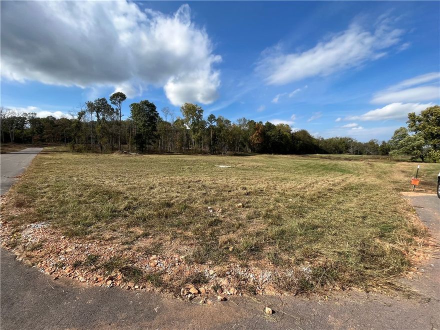 3.87 acres of wooded, gently rolling land.  Residents enjoy access to a 7+ acre common area along Little Osage Creek that runs through the neighborhood.  This neighborhood is perfect for fishing, exploring, or relaxing.  Utilities are available at the street. This property combines a peaceful retreat with quick access to everything Northwest Arkansas has to offer.