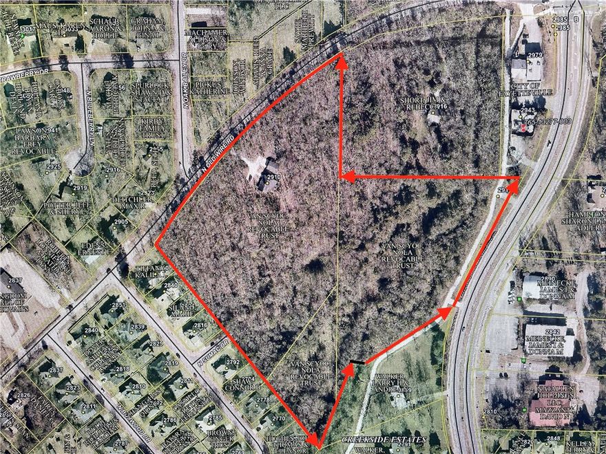 Rare acreage inside if 265 in NE Fayetteville.  This +/-14 acre property has lots of potential either as a private estate or infill development.  Property includes Niokaska Creek running thru the southern border as well as Niokaska Creek Trail connecting to Gulley Park and Mud Creek Trail on to the Razorback Greenway.  Property has almost 840 feet of frontage on N Old Wire Rd and has a street stub, N Sumac Dr, which adjoins Raintree Drive to the west.  Property is currently zoned NC and RA in 3 parcels.  Creek area contains flood-plane/floodway per FEMA maps.  Property includes one 1948 soft SFR built in 1960 along with a 2 car detached garage.  Potential for homesite to be split off.