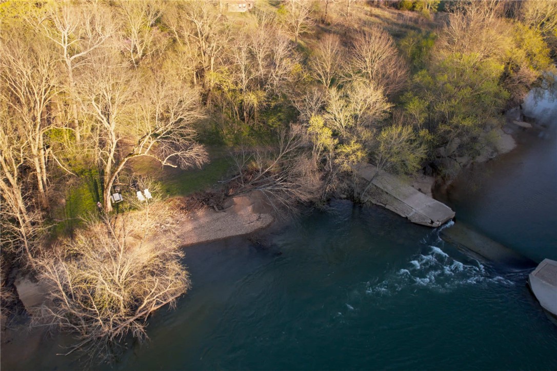 Fantastic opportunity to own a one of a kind property located directly on the banks of the gorgeous Kings River. This property is split between two parcels on either side of Highway 221. The land includes a future homesite with electric hookup, a riverside sandbar, and a deep water swimming hole. Located just 15 minutes from Eureka Springs and 10 minutes from Berryville, this hidden gem is busting with untapped potential.