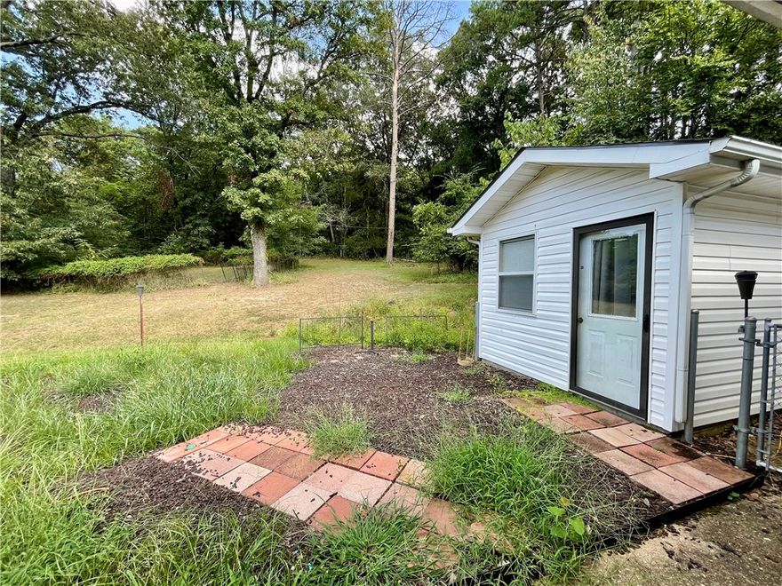This 4 acre property presents a rare opportunity to own more than a small lot within the city limits, boasting a picturesque park-like setting and effortless access to local amenities. The 2-bedroom, 2-bathroom residence offers 1680 sq ft of living space, office/flex room off the kitchen, further enhanced by a spacious 288 sq ft screened porch/sunroom in the front entrance of the home. A separate 10x16 building provides versatility for use as an art studio, office, or guest room.Ample storage space is available in the garage. This home showcases character and charm, set amidst a serene 4-acre backdrop within the city limits.With convenient access to Hwy 412, discover NW AR's comprehensive trail network featuring biking, hiking, and mountain biking trails.Enjoy a variety of outdoor pursuits, including camping, fishing, and water sports, with easy access to Beaver Lake, War Eagle Creek, and the Buffalo National River. Utility availability is the responsibility of the buyer or buyers agent.