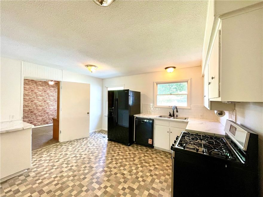 This 4 acre property presents a rare opportunity to own more than a small lot within the city limits, boasting a picturesque park-like setting and effortless access to local amenities. The 2-bedroom, 2-bathroom residence offers 1680 sq ft of living space, office/flex room off the kitchen, further enhanced by a spacious 288 sq ft screened porch/sunroom in the front entrance of the home. A separate 10x16 building provides versatility for use as an art studio, office, or guest room.Ample storage space is available in the garage. This home showcases character and charm, set amidst a serene 4-acre backdrop within the city limits.With convenient access to Hwy 412, discover NW AR's comprehensive trail network featuring biking, hiking, and mountain biking trails.Enjoy a variety of outdoor pursuits, including camping, fishing, and water sports, with easy access to Beaver Lake, War Eagle Creek, and the Buffalo National River. Utility availability is the responsibility of the buyer or buyers agent.