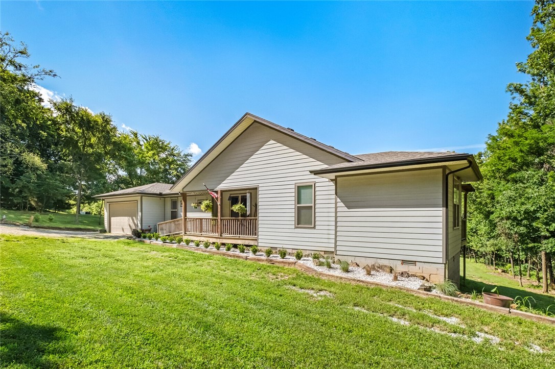 Welcome to your peaceful retreat! This beautifully maintained 3-bedroom, 2-bath home, built in 2017, is nestled on 12.52 mostly wooded acres—perfect for those seeking privacy, nature, and functionality all in one. Step inside to find hardwood floors, granite countertops, and an impressive pantry with plenty of storage space. A cozy woodstove adds warmth and rustic charm, keeping you toasty during the colder months. Enjoy quiet mornings on the inviting front porch or host gatherings on the expansive 12x50 back deck—all while taking in views of deer and other wildlife roaming the property. The land includes two ponds and a cute, fenced-in garden ready for your green thumb. The separate 24x36 shop is fully equipped with electricity, plumbing, and even a half bath—making it ideal for projects, storage, or a future guest space. This one-of-a-kind property has everything you need to live comfortably and close to nature, including incredible trails for ATV riding! Schedule a showing, this is one you won't want to miss!