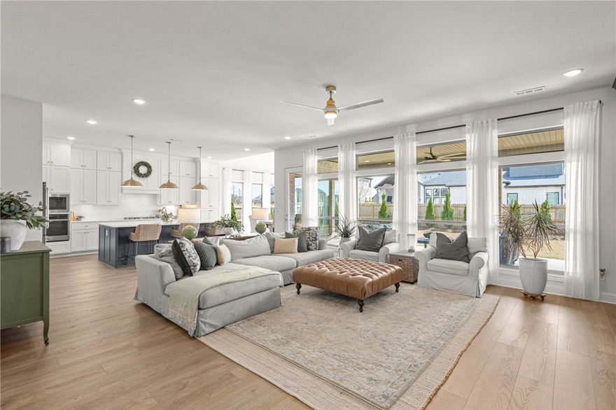 Move-in ready Evening Star residence showcasing refined upgrades & exceptional attention to detail. Professionally landscaped grounds set the tone for an impeccably curated interior featuring designer lighting, custom fireplace surround, stair runner, drapery & automated blinds. Main living area offers a serene, light-filled space with built-ins and a statement fireplace. Kitchen is appointed with quartz countertops, gas cooktop, built-in oven & walk in pantry. Elegant dining space. Enjoy outdoor living on the covered patio. Functional luxury continues with a spacious laundry and mudroom off the 3-car garage. The main level hosts two guest suites with walk-in closets and a dual-vanity guest bath. The private primary retreat features wood floors, abundant natural light, and a spa-inspired bath with soaking tub, large walk-in shower, and WIC. Upstairs offers a secondary living area and en-suite bedroom. All located in highly sought after community with amenities, near schools, and Pinnacle district.