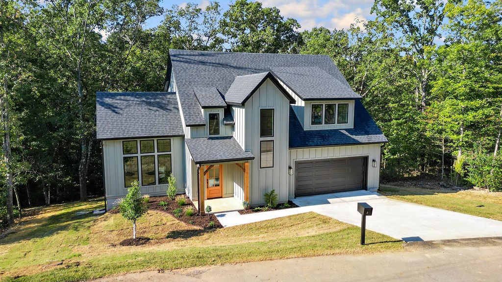 Stunning new construction blends Mountain Modern style with natural materials and farmhouse warmth. This 4-bedroom, 2.5-bath, 2,340 sq ft home features tall ceilings, oversized windows, exposed beams, white oak flooring, modern finishes, and champagne bronze fixtures. The open-concept main floor flows effortlessly from the living area with gas fireplace to a dedicated dining space and kitchen with large island and stainless appliancesāperfect for entertaining. The main-level primary suite offers a spa-like retreat with dual vanities, soaking tub, separate shower, and walk-in closet with washer/dryer connections. Upstairs, a bonus space, two bedrooms, a full bath, and second laundry add convenience. Step outside to the 154-sq ft covered back deck with gas connection and wrought iron railings ensuring an inviting space for relaxation. Located just 11 miles to the Walmart Home Office and downtown Bentonville, this home combines modern luxury with a peaceful, stylish retreat. Taxes are on lot only. Home is on SEWER!