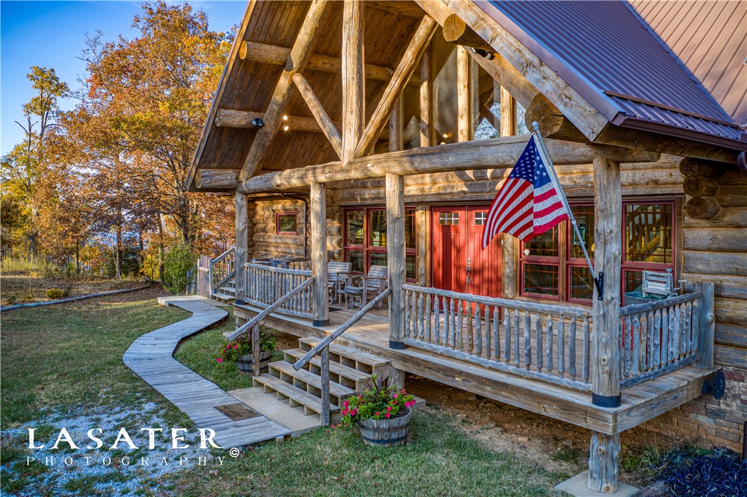 Custom large Montana log home & a million-dollar mountaintop view over Jasper & the Buffalo River Valley. 40-mile visibility to Branson. Custom interior woodwork. 14.2 well-manicured acres. Beautiful large spring fed stocked pond. Enter property thru pastureland past pond to home. Enjoy backyard views from 3 deck levels with views and shooting range. 15 minutes from Buffalo National River and Johnny Morris upcoming Marble Falls Natural Village. Large 2 car garage. Elevator and handicap accessible.