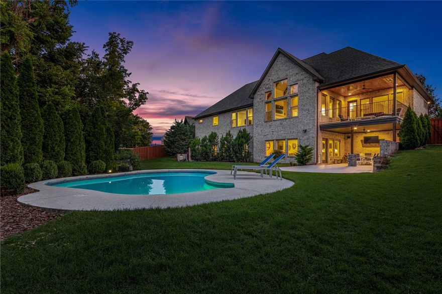 This home features an incredible outdoor living space on large, private lot. Foyer entry w/access to large home office. Dining space opens to amazing kitchen & access to deck. Kitchen boasts massive island, 6burner gas range w/pot filler & hidden pantry! Stunning living room has 20' ceilings, large windows & fireplace. Covered deck is great for relaxing year-round w/built in heaters & beautiful views of pool & woods. Main level guest en-suite. Storage built ins off garage entry & large laundry room. Spacious primary suite is an owners retreat w/attached bath w/huge walk-in shower, soaking tub, WIC. Downstairs is the 2nd living space w/large wet bar area & access to the outdoor kitchen and dining area and the pool. Media Room. Second laundry/util room has dog wash area & attached workout room. 2 guest rooms on lower level attached by jack & jill bath. Outside enjoy the heated, saltwater pool by relaxing on the patio space and wooded views. Fully fenced w/great yard space. Extra storage/workshop accessible via yard.