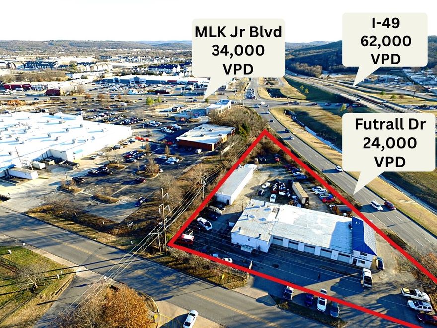 High traffic location with 24,000 vehicles per day and frontage on two sides.  Two buildings with 9,817 sf with upstairs office space in main building.  Office areas heated and air conditioned.  There are several commercial options for use with this space. Office areas are heated and air conditioned.  Zoning C-2 for retail, restaurant, medical and multi-family.  Direct access to I-49 and Futrall Drive.  This listing is for property and building....machinery, tools and book of business does not convey.  Owner financing possibilities.