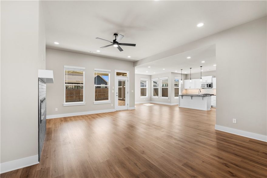 Beautiful Move in Ready Home in Wakefield Park! Spacious Open Floorplan and 4 Bedroom Layout! Home features include LVP Flooring, Granite Counters, Electric Fireplace, and Full Privacy Fencing. Foyer entry welcomes you into the large living space with great natural lighting and beautiful fireplace feature. The eat in kitchen has great workspace, including a gas cooktop and large pantry, refrigerator included! Dining space has large windows looking out to your backyard and access to the covered patio. Primary suite has tray ceiling detail and an attached bath with dual vanity, whirlpool tub, separate shower, and WIC. 3 guest bedrooms and 2 guest bathrooms offer great additional space for any buyer! 2 Car Garage. Located in a quiet new neighborhood across the road from state park. Nearby schools as well as shopping and dining and just 15 minutes to Fayetteville and I-49! Welcome Home!