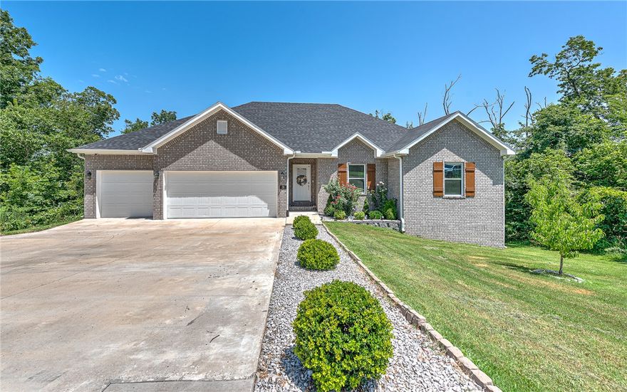 Tucked into the wooded hills of Bella Vista, this home delivers that perfect blend of modern comfort and natural beauty— minutes from Loch Lomond, Scotsdale Golf Course, and miles of bike trails. This thoughtfully designed home offers 3 bedrooms, 3 full baths, and over 2,500 square feet of flexible living space, including a walk-out lower level and spacious bonus room ideal for guests, hobbies, or a home office. The heart of the home features a stylish kitchen with granite surfaces, custom cabinetry, and a layout made for connection—flowing into a light-filled living room and dining area. Retreat to the private primary suite with a soaking tub, spa-style tile shower, dual vanities. Outside, enjoy your tiered deck system, where tranquil views of the treetops offer a peaceful backdrop to morning coffee or evening gatherings. A generous three-car garage, energy-efficient upgrades, & close proximity to shopping, trails, and the Bella Vista Bypass make this home both a serene hideaway and a smart lifestyle investment.