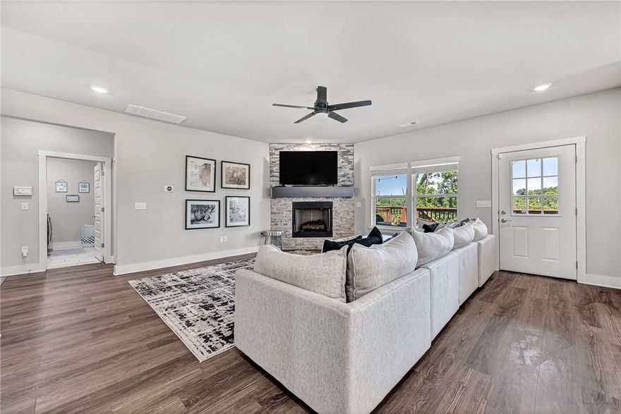 Tucked into the wooded hills of Bella Vista, this home delivers that perfect blend of modern comfort and natural beauty— minutes from Loch Lomond, Highlands Golf Course, and miles of bike trails. This thoughtfully designed home offers 3 bedrooms, 3 full baths, and over 2,500 square feet of flexible living space, including a walk-out lower level and spacious bonus room ideal for guests, hobbies, or a home office. The heart of the home features a stylish kitchen with granite surfaces, custom cabinetry, and a layout made for connection—flowing into a light-filled living room and dining area. Retreat to the private primary suite with a soaking tub, spa-style tile shower, dual vanities. Outside, enjoy your tiered deck system, where tranquil views of the treetops offer a peaceful backdrop to morning coffee or evening gatherings. A generous three-car garage, energy-efficient upgrades, & close proximity to shopping, trails, and the Bella Vista Bypass make this home both a serene hideaway and a smart lifestyle investment.