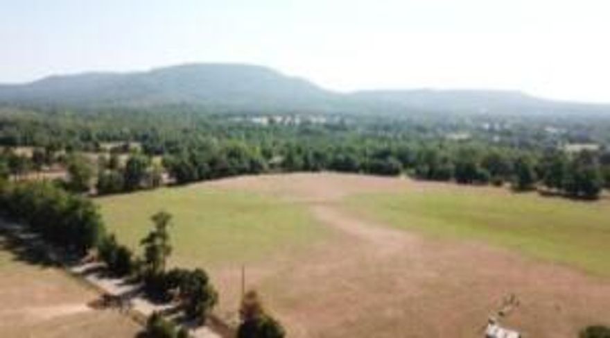Custom Financing options available!Discover 5 magnificent acres featuring stunning mountain scenery and a gentle creek at the back of the property.Create your ideal retreat in this stunning environment!!