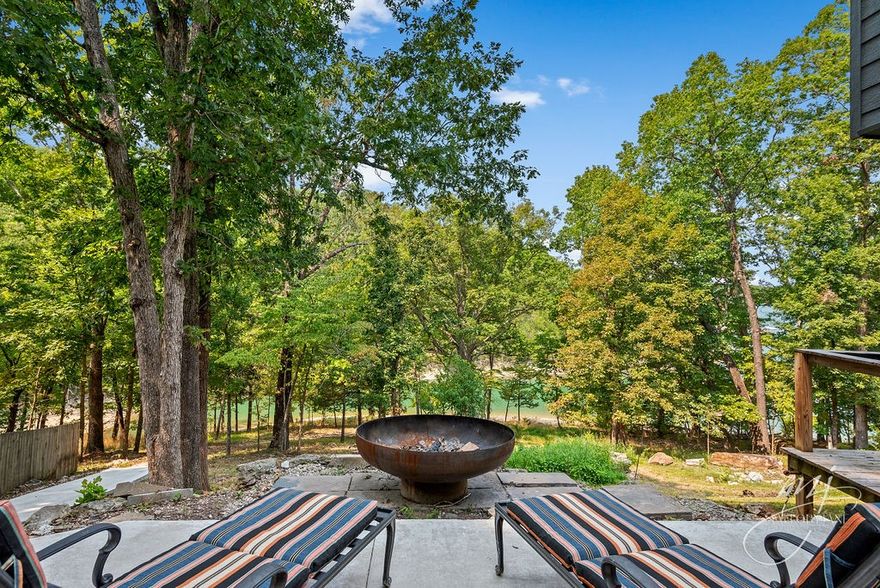 Life's a BEACH! Rare Arkansas beach-front with gentle WALK TO THE WATER on the quiet, coveted Emerald Bay- sparkling emerald waters, lovely landscapes and gorgeous views rise to greet you. Completely renovated, top to bottom with luxurious finishes and custom craftsmanship. Professional interior designer made this home shine! Boasting three separate living spaces with sensational views and custom gourmet kitchen complete with professional "Monogram Supreme" gas range with hood (coming soon), imported "Leathered" granite and stunning onyx floors throughout. All New HVAC, plumbing, electric and MORE~ This beauty is a rare find- don't miss out! CAN SLEEP 12 OR MORE with separate entrances available! See attached list of bonuses, SPD and additional info on this immaculate home. Basement with full bath and both master baths(main and upstairs) are in full reno-Est complete date end of Sept. WOW-tile- double shower, European Soak tub and huge walk in closet in new (upstairs) master.