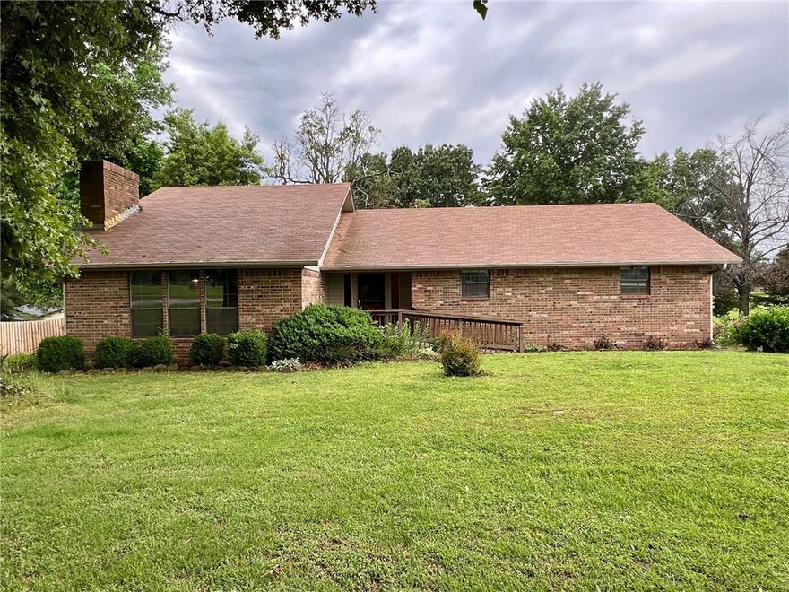 Nice ranch style house on 1.62 acres with great access to major hwys connecting you to all of NWA in minutes. Home features 3 bedroom, 2 full bathrooms, eat in kitchen, screened in large back deck, bonus loft area above living room, hardwood trees on large nice lot, all appliances, and detached two car garage/shop.