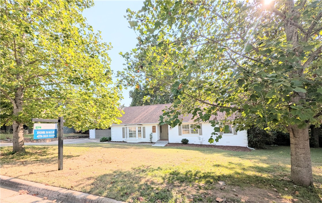 A must see! Newly updated, 2300+ sqft, home nestled near UAFS & I-540 in a charming neighborhood with great neighbors! This home has 3 bedrooms/2 baths as well as a large 400 sqft. heated and cooled sunroom filled with casement windows overlooking the shaded backyard. A nicely sized deck on the back is perfect for outdoor entertaining. Large living room with bay windows, wet bar, formal dining/sitting room with gas fireplace and a breakfast nook. The 2 car garage has full access stairs to the attic which is decked for lots of storage. Roof is 2 years old and the HVAC is 5 years old. Water heater, central heat, and cooktop are all natural gas.