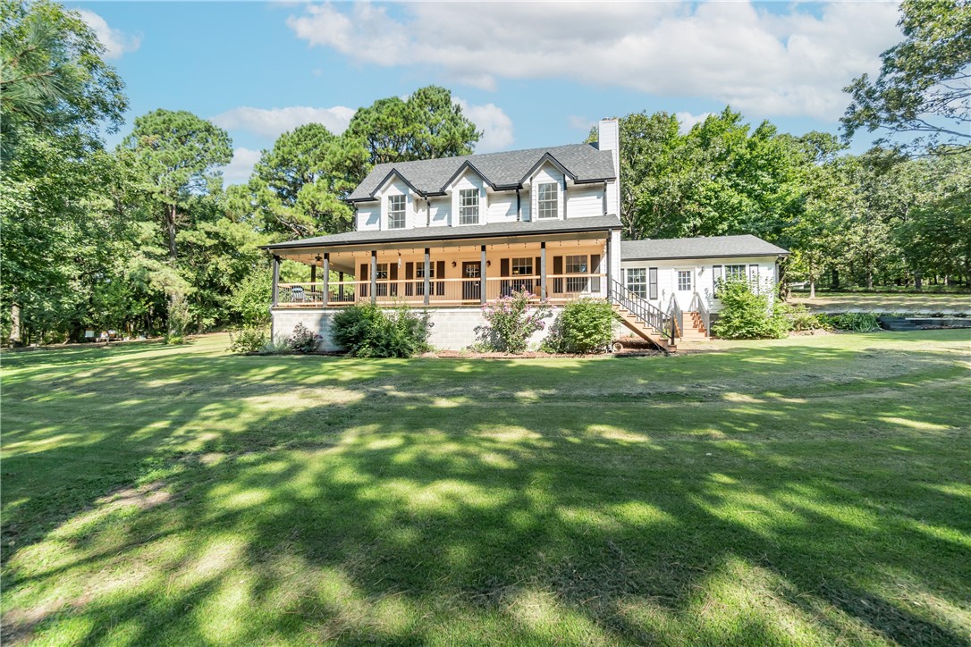 Enjoy the comfort and tranquility of this country home on 6.5 acres of land, featuring a pond, a fenced area for your pets, and a large deck with ceiling fans. This home has spacious bedrooms, dual A/C units, and a beautiful setting. You will also love the easy access to the Northwest Arkansas region, where you can find shopping, dining, entertainment, and more. This home offers privacy and seclusion, away from the hustle and bustle of the city. You will have the freedom to live as you please, without any city limits or restrictions. You will also appreciate the scenery and trees that surround this property, giving you a sense of peace and harmony.